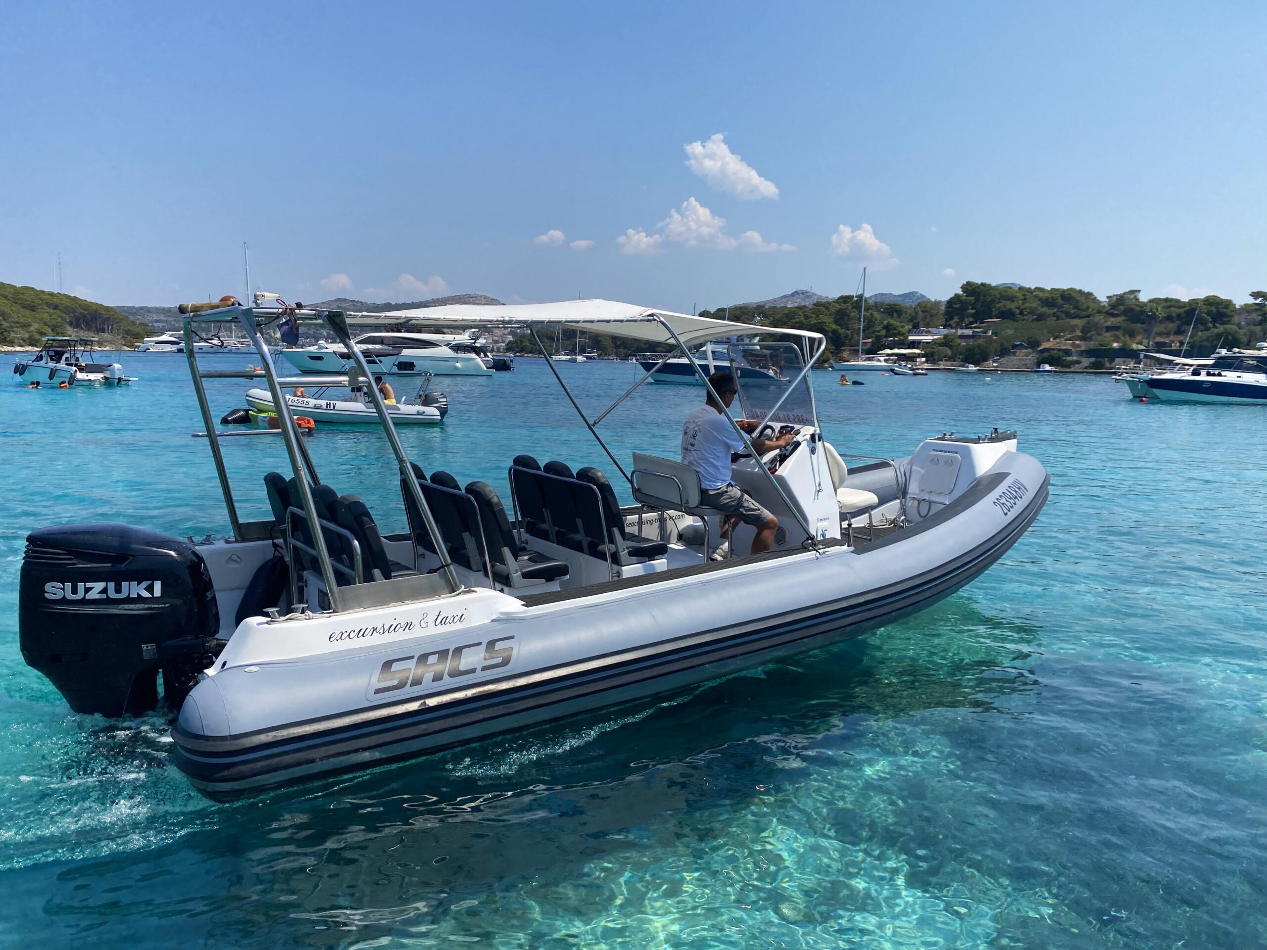 Boat taxi running across the clear water near Hvar